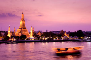 Wat Arun across Chao Phraya river during sunset