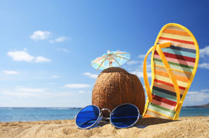 Coconut and flip-flops on a beach